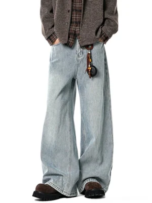 Light washed blue wide-leg barrel jeans with relaxed oversized fit styled with brown cardigan and suede shoes