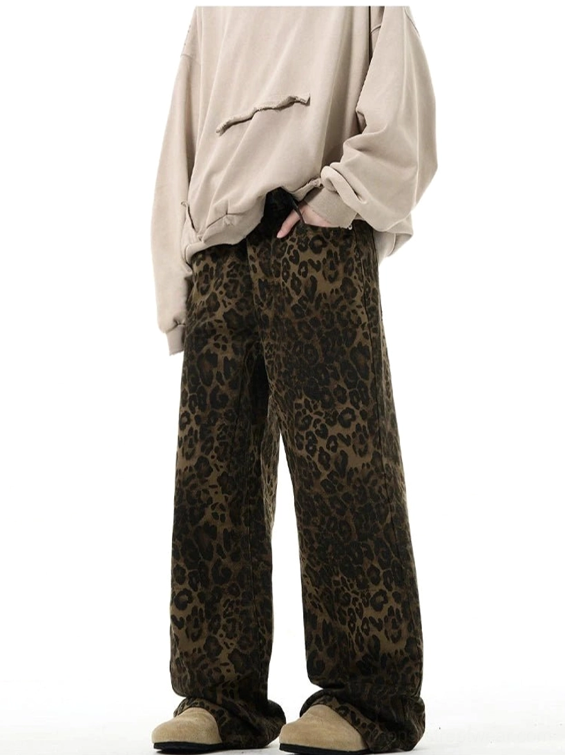Vintage wash leopard print denim trousers with high waist and relaxed wide leg silhouette