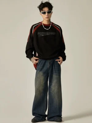 Full front view of vintage wash wide-leg denim jeans styled with a graphic sweatshirt and silver necklace in Korean streetwear fashion