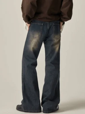 Rear full-body view of blue vintage wash wide leg jeans showing twin back patch pockets and relaxed streetwear fit