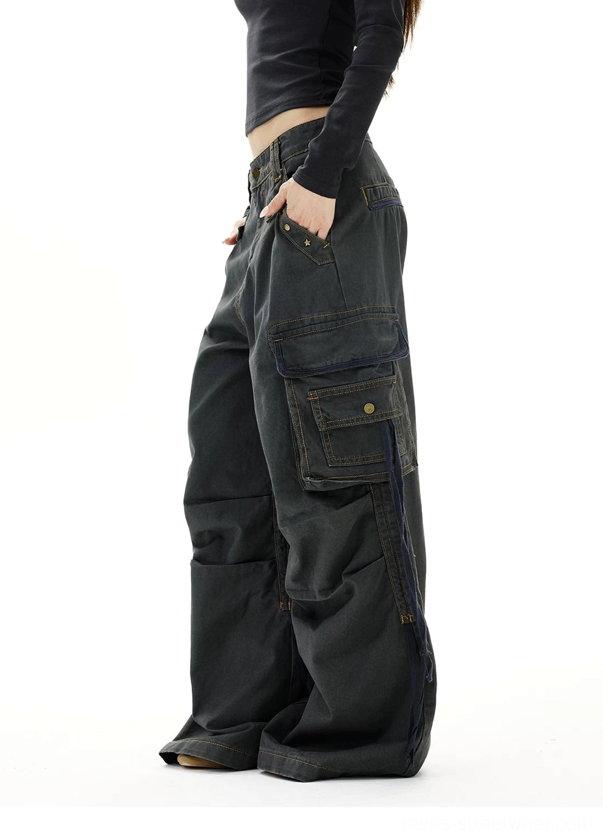 Dark gray baggy cargo jeans left side view showing oversized side pocket, utility straps, and stacked wide leg fit