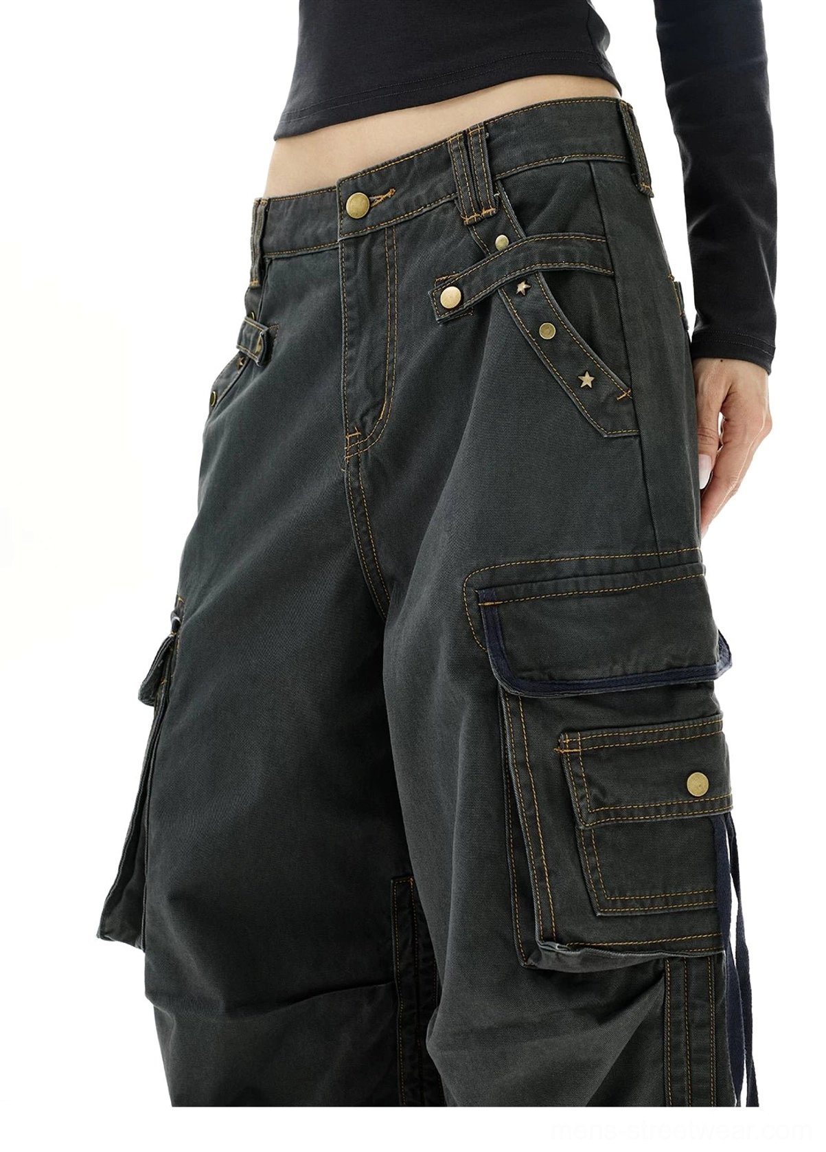 Close-up of dark gray strap cargo jeans waist and side pocket with brass-tone snap hardware and contrast stitching