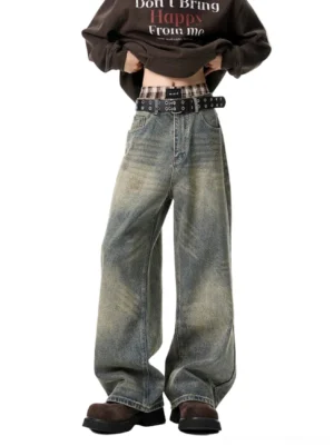 Vintage washed baggy wide-leg jeans front full-body view styled with brown graphic sweatshirt, belt, and work boots