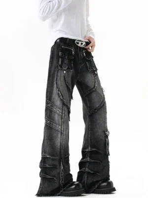 Front three-quarter view of vintage washed black flared cargo jeans featuring front utility pockets, raw frayed seam details, rivets, and black boots