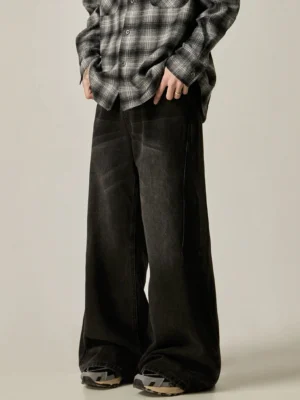 Side front view of vintage washed black wide-leg denim jeans with relaxed Korean streetwear styling and casual sneakers