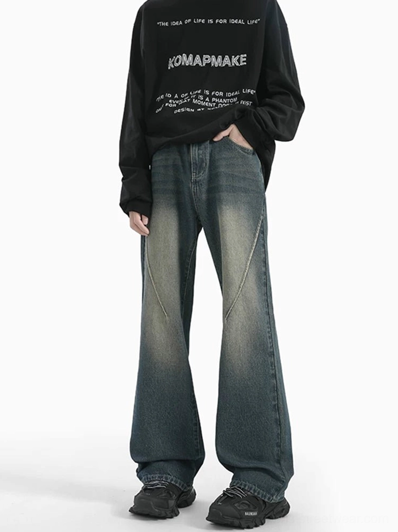 Front view of vintage washed blue arc flare denim pants showing curved seams, roomy thighs, and wide-leg styling