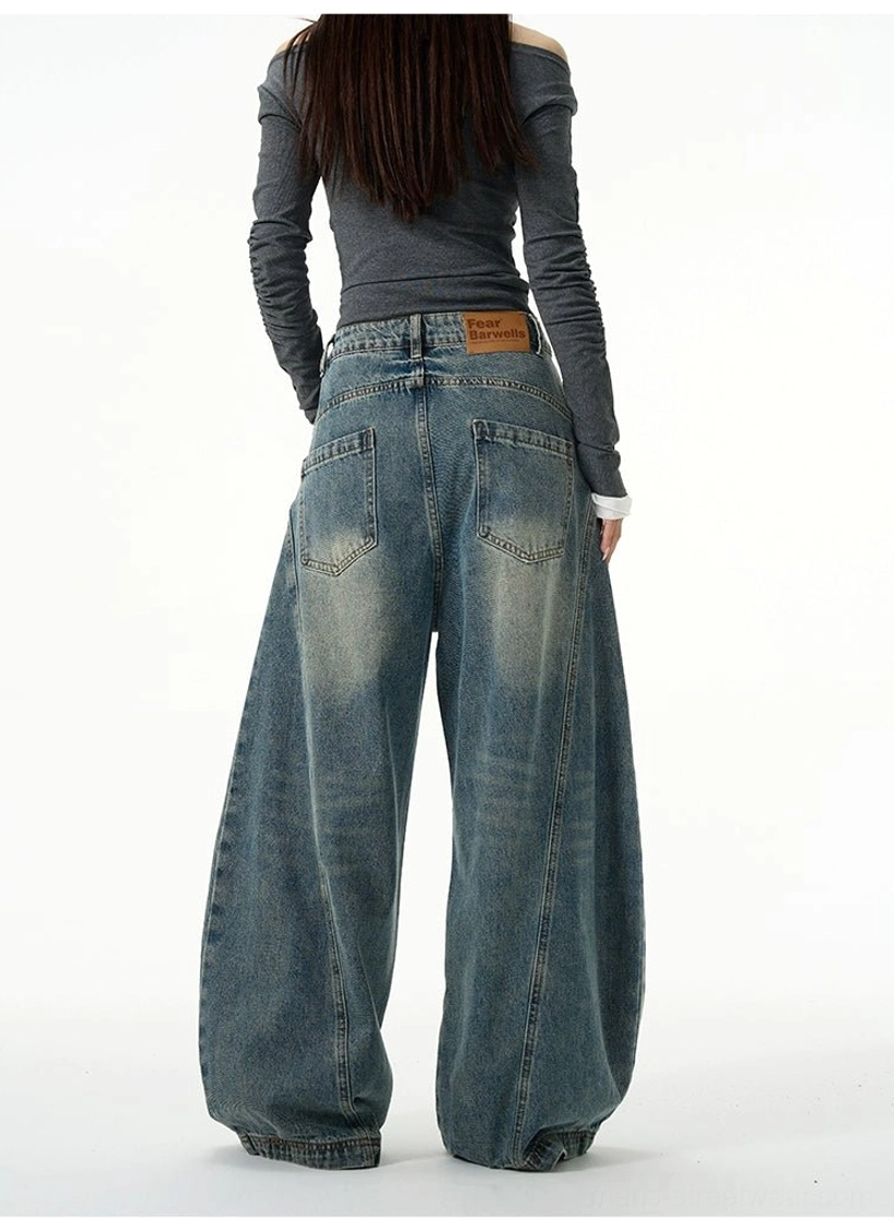 Back full-body view of vintage washed blue balloon jeans showing back pockets and oversized rounded silhouette