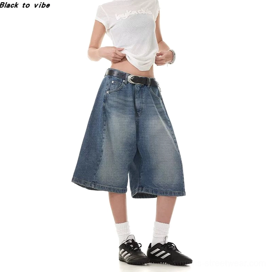 Close streetwear view of vintage washed blue denim Bermuda shorts showing textured denim and side seam details