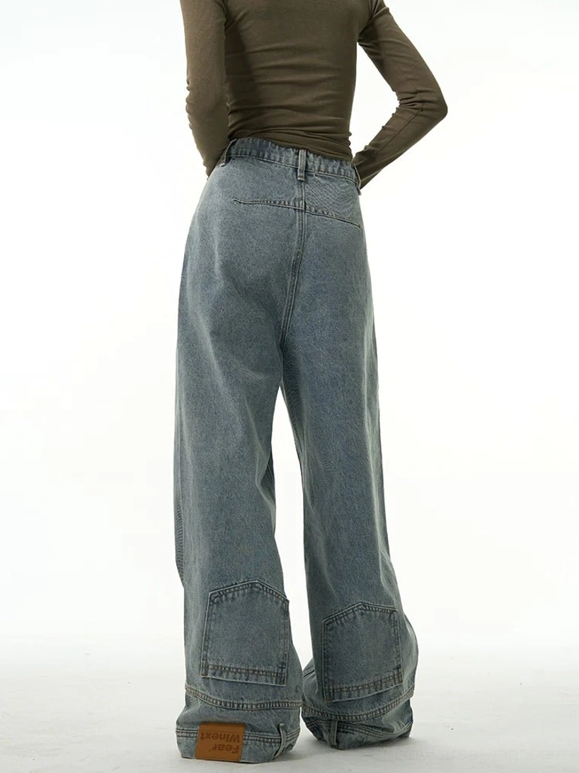 Rear view of vintage washed blue inside-out wide-leg jeans with rear patch pockets, layered cuffs, and relaxed streetwear fit