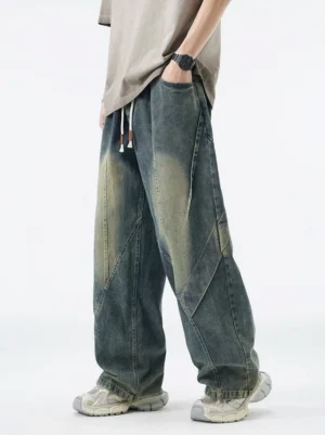 Vintage washed blue paneled drawstring wide-leg jeans front three-quarter view with diagonal seam details