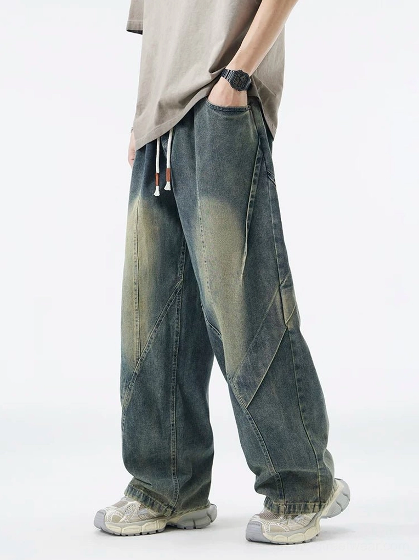 Vintage washed blue paneled drawstring wide-leg jeans front three-quarter view with diagonal seam details