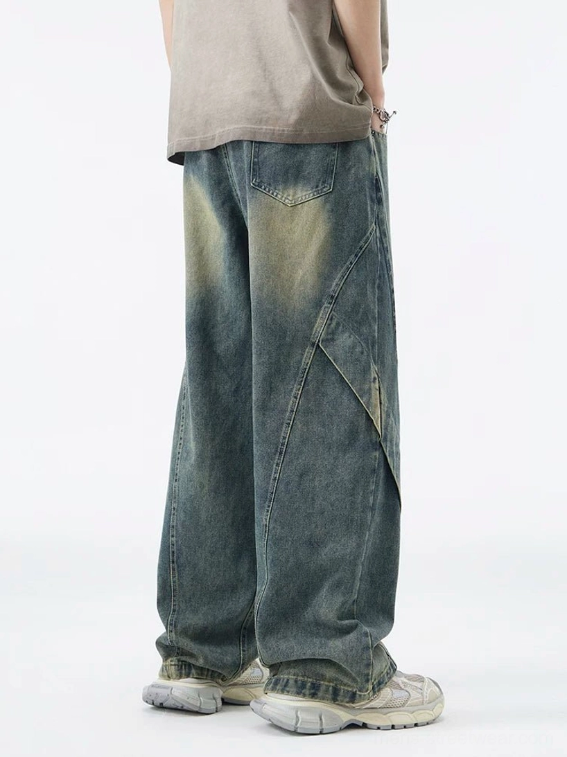 Vintage washed blue wide-leg jeans back view showing relaxed baggy fit rear pockets and diagonal panel seams