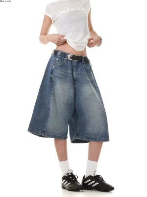 Vintage washed blue wide-leg denim Bermuda shorts shown in a left front three-quarter streetwear outfit view