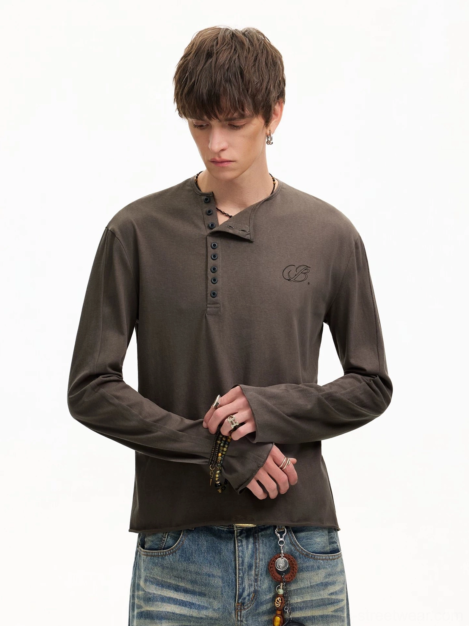 Three-quarter view of a vintage washed brown Henley long sleeve T-shirt with half-button placket and subtle chest embroidery