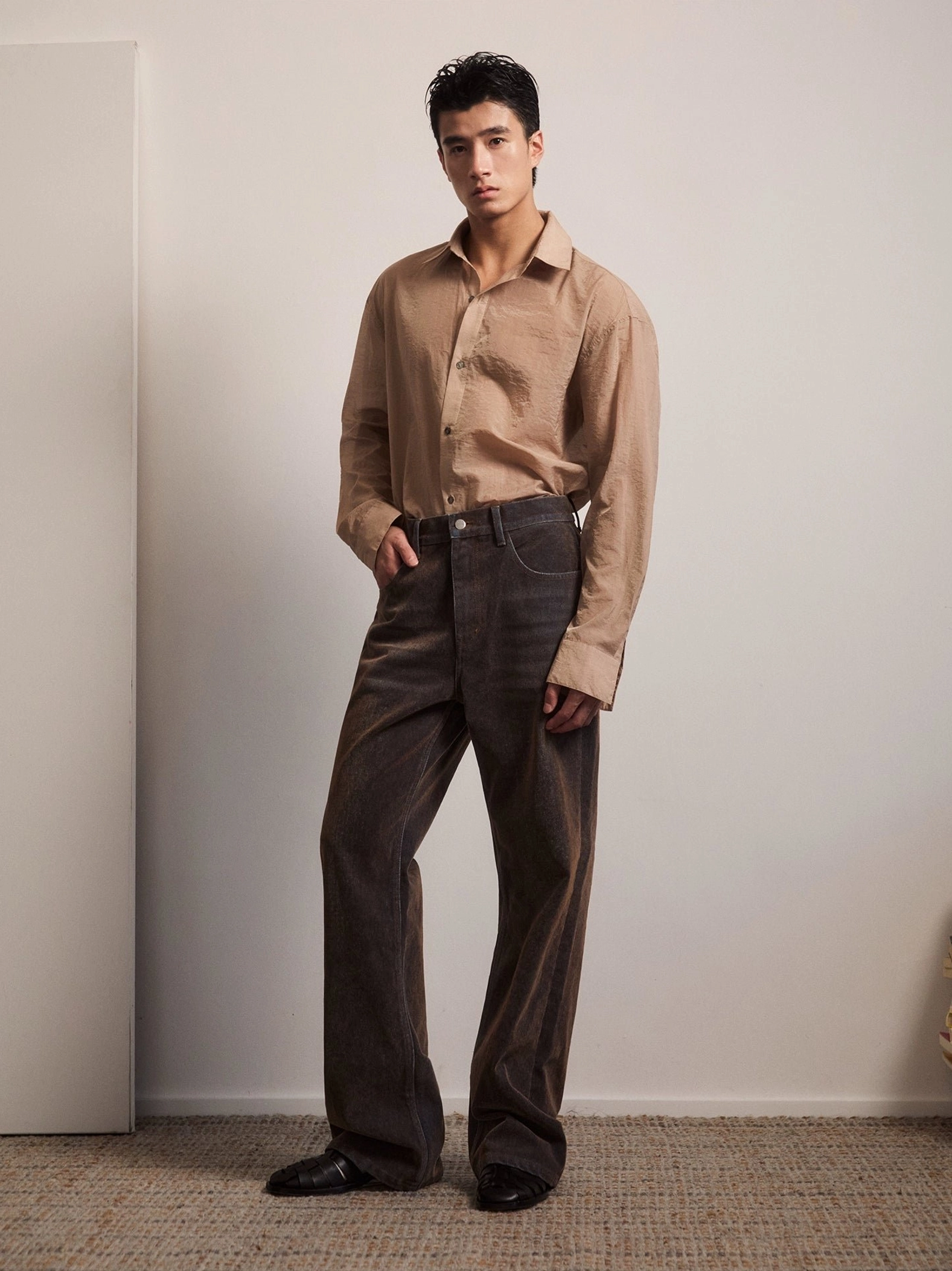 Vintage washed brown high rise flare jeans front full body view with relaxed wide leg streetwear silhouette