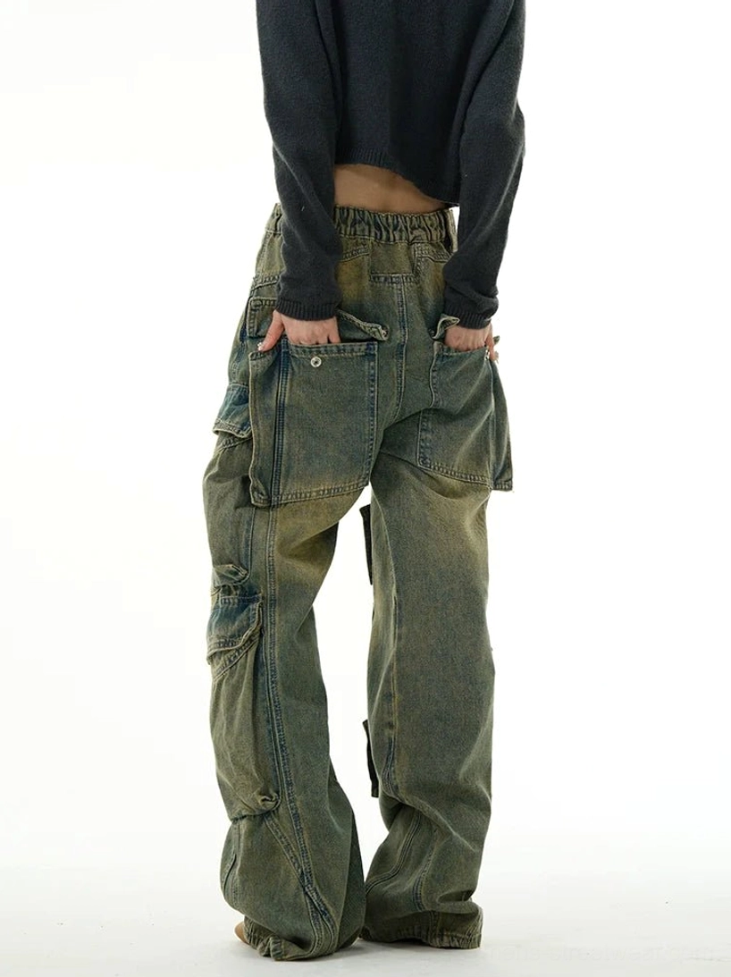 Back view of vintage washed cargo denim jeans with large patch back pockets, elasticated rear waistband, and oversized side utility pockets