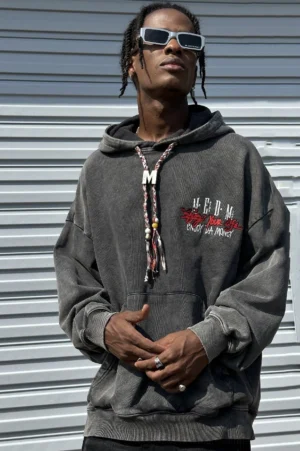 Vintage washed charcoal gray oversized embroidered streetwear hoodie worn by male model with braided drawstring and kangaroo pocket