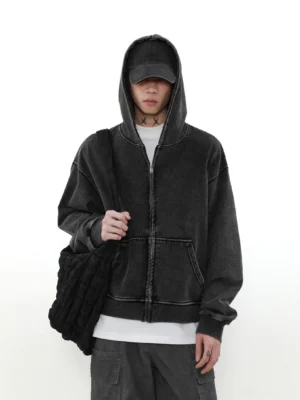 Faded charcoal vintage zip-up hoodie front view showing full zipper contrast seams kangaroo pocket and relaxed streetwear fit