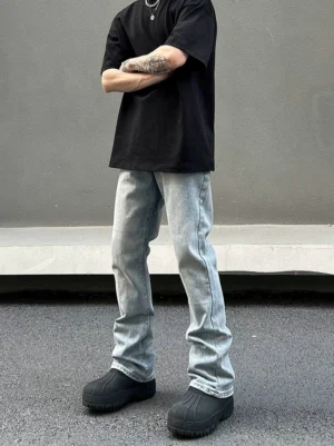 Front side view of vintage washed ice blue flared straight leg jeans styled with a black T-shirt and boots