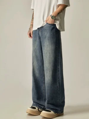 Vintage washed loose straight-leg denim jeans in faded blue shown from the rear three-quarter view with relaxed wide-leg streetwear fit
