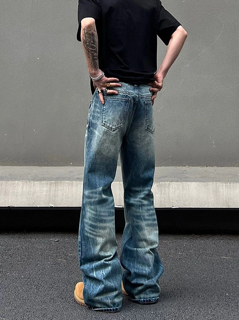 Rear full body view of vintage washed wide leg jeans showing classic back patch pockets and faded blue denim