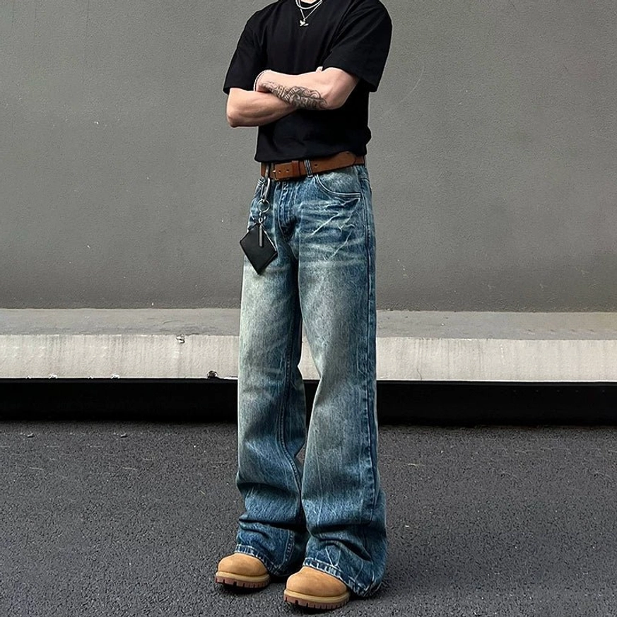 Front full body view of blue vintage wash wide leg jeans with relaxed fit long legs and tan work boots