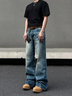 Front full body view of vintage washed blue wide leg jeans styled with a black t-shirt and tan work boots