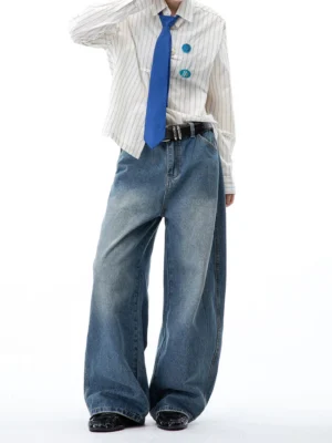 Model wearing vintage washed wide-leg jeans with a striped shirt, blue tie, black belt, and leather shoes in a smart Seoul streetwear look