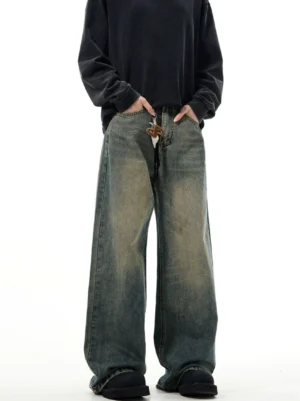 Close front view of vintage wide-leg denim jeans showing relaxed baggy fit, faded indigo wash, and adjustable drawstring waist