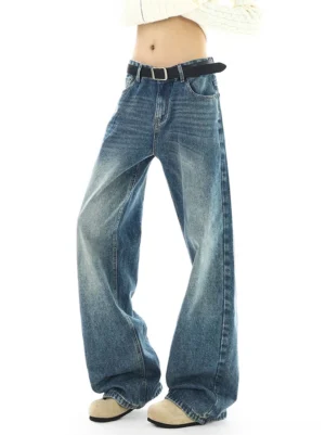 Front three-quarter view of vintage medium blue wide-leg jeans with faded thigh whiskering, high-rise waist, and relaxed Korean streetwear silhouette