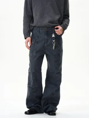Front view of dark charcoal vintage wide-leg cargo pants with panel seams, flap pockets, and Korean streetwear styling on a male model