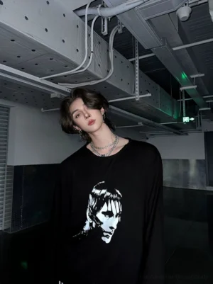 Black oversized monochrome portrait graphic long sleeve streetwear tee chest detail in an industrial setting