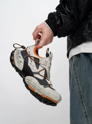 Off-white black and burnt orange Volcano Ridge tech trail sneakers with bungee lacing and chunky rugged outsole