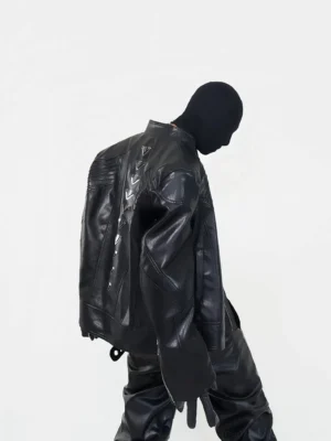 Black oversized PU leather streetwear biker jacket with metal pyramid studs along the back shown in rear side view