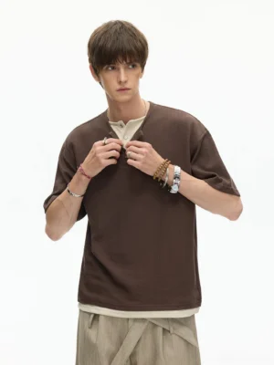 Brown waffle knit layered Henley T-shirt with button placket styled with beige wide-leg trousers