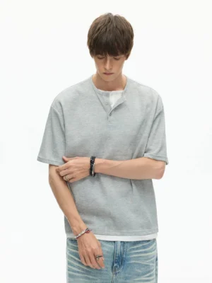 Heather gray waffle knit layered Henley T-shirt in relaxed Korean streetwear fit with blue denim jeans