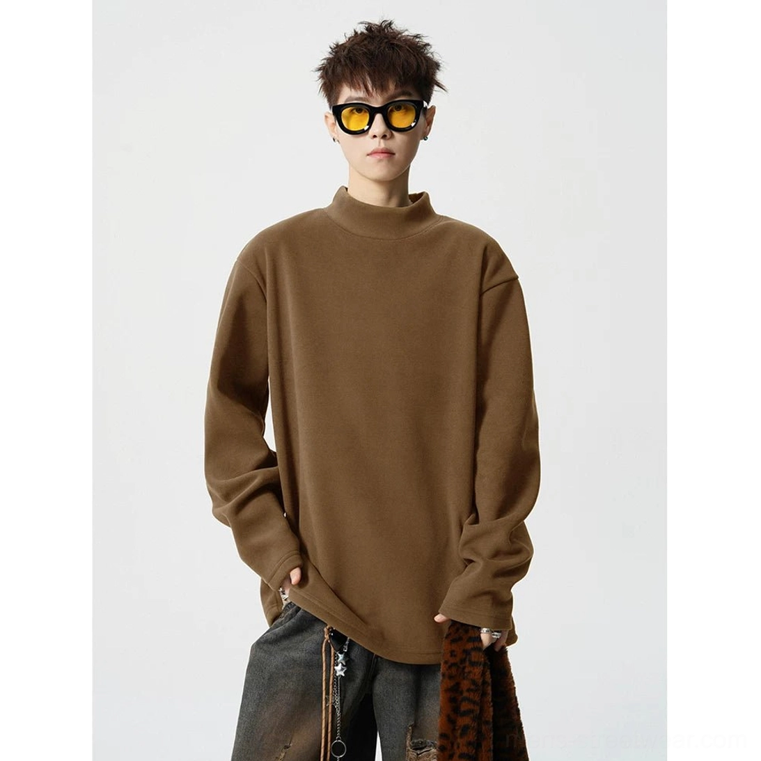 Warm brown boxy mock neck fleece long sleeve top styled with baggy denim and contemporary streetwear accessories