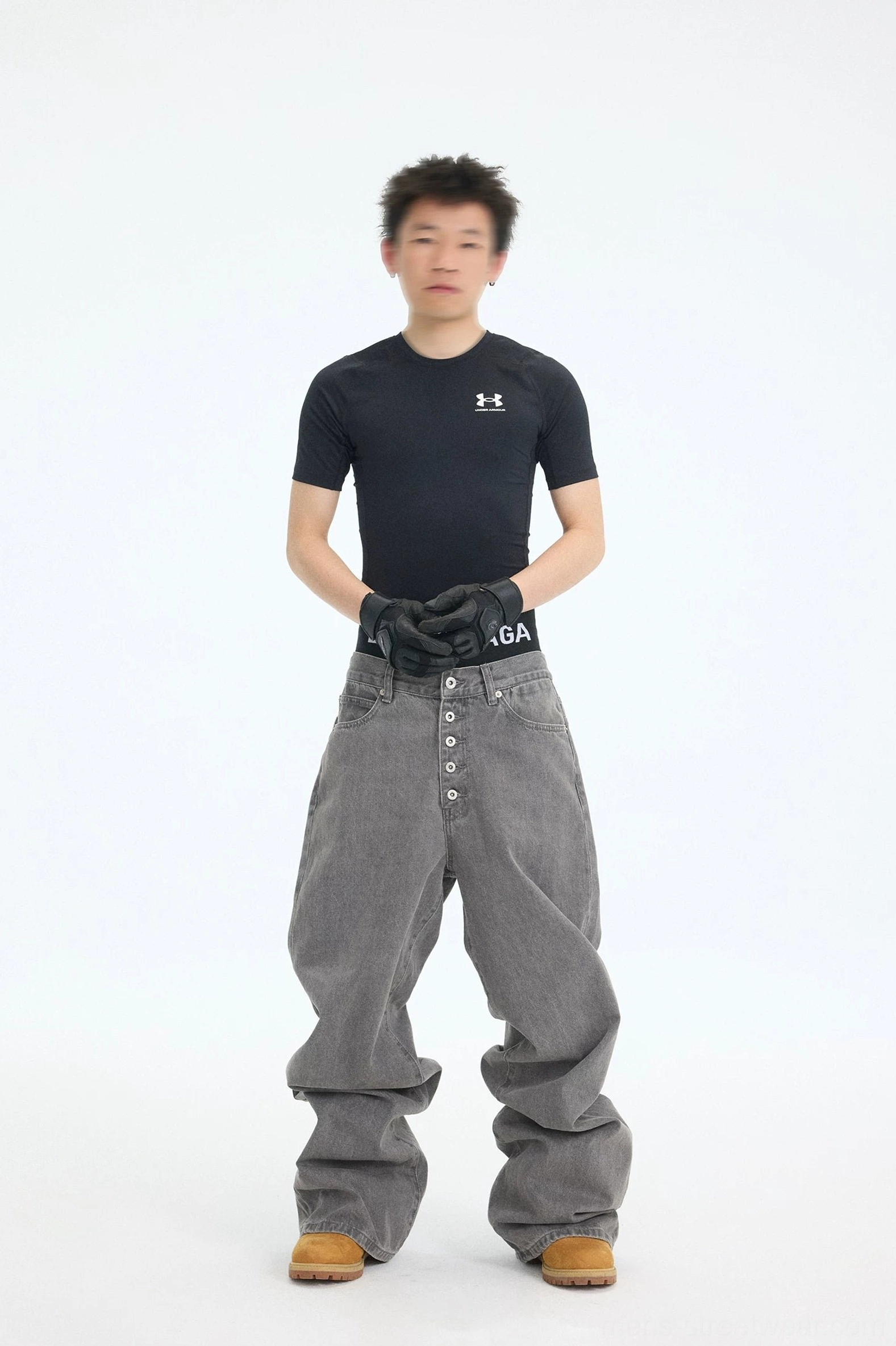 Complete front view of washed ash stacked baggy jeans styled with boots, showing the wide leg and relaxed streetwear proportions