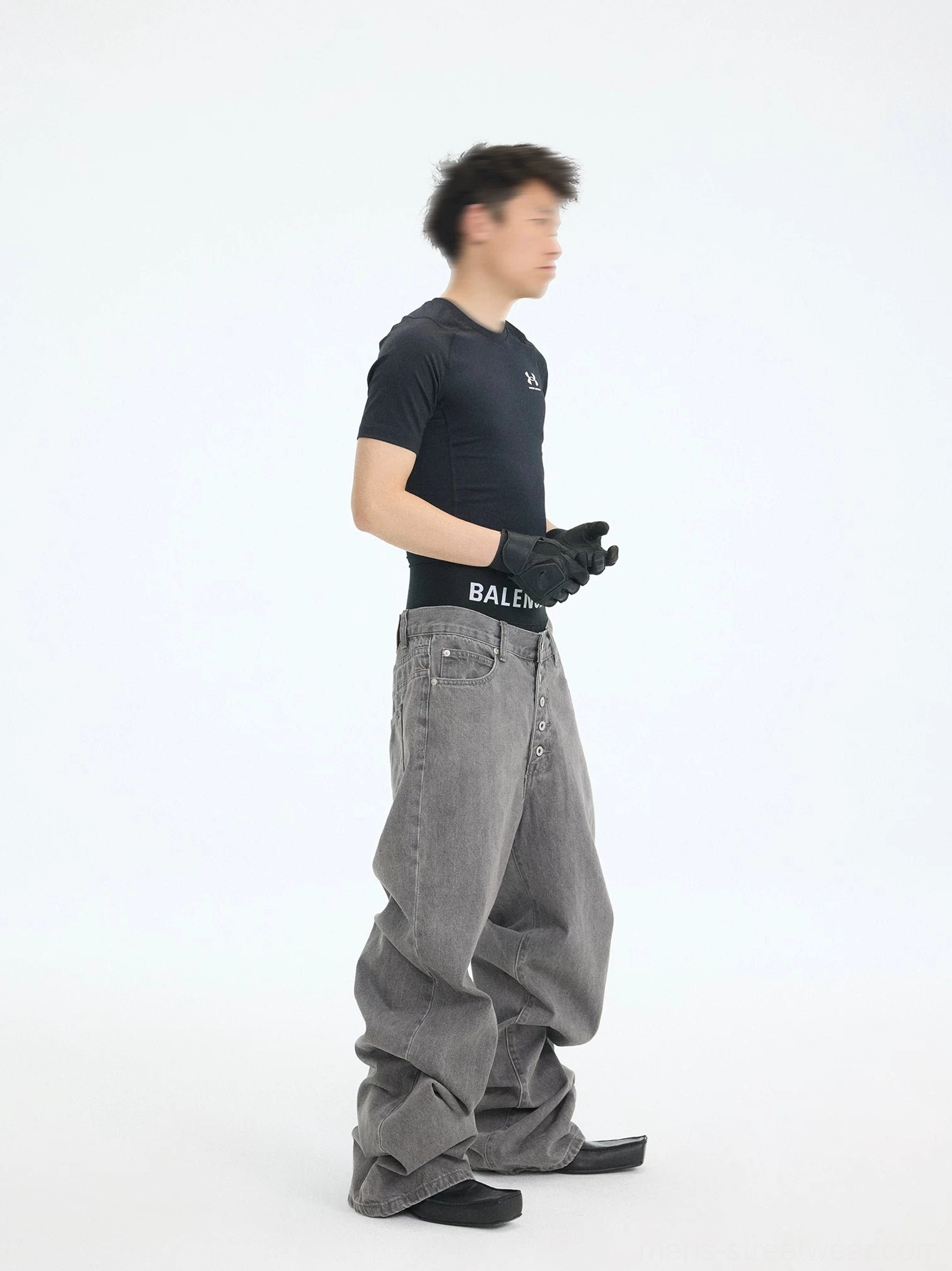 Side profile of ultra-wide washed ash jeans with a fluid draped silhouette, full length, and modern Korean streetwear fit
