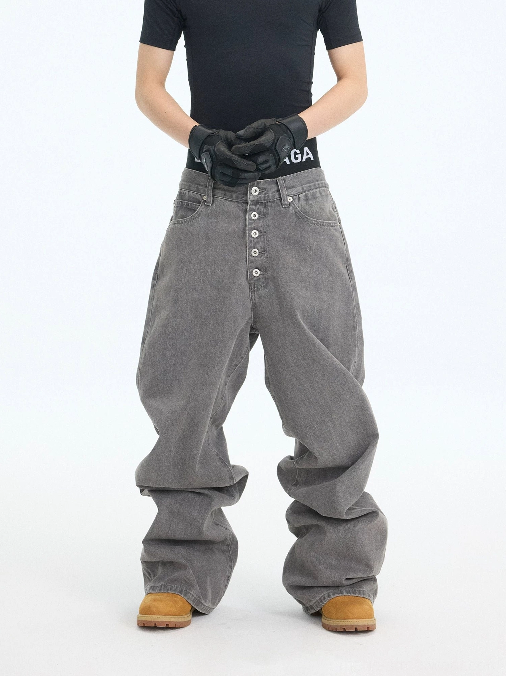 Front view of washed ash wide-leg stacked jeans with five-button fly, oversized streetwear fit, and relaxed workwear styling