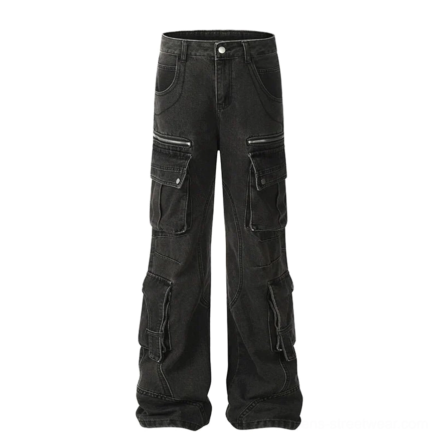 Flat lay of washed black cargo denim jeans showing full wide-leg silhouette, oversized pockets, metal snaps, and side zippers