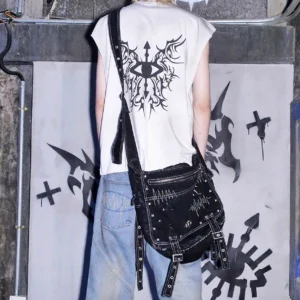 Back view of washed black denim cyberpunk crossbody leg bag with industrial buckle straps worn by male streetwear model
