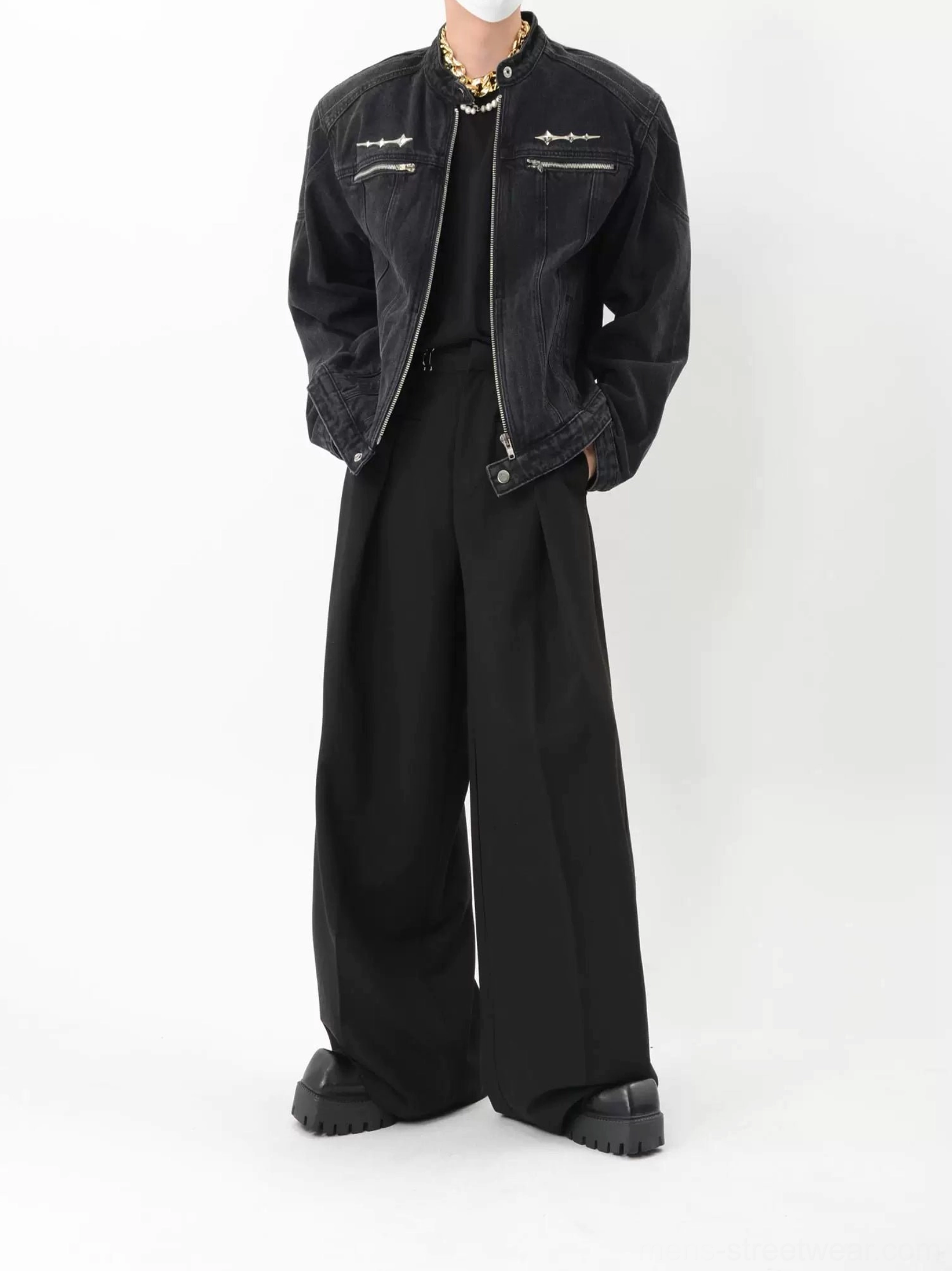 Back three quarter view of washed black denim biker jacket with relaxed dropped shoulder silhouette and adjustable waist tabs