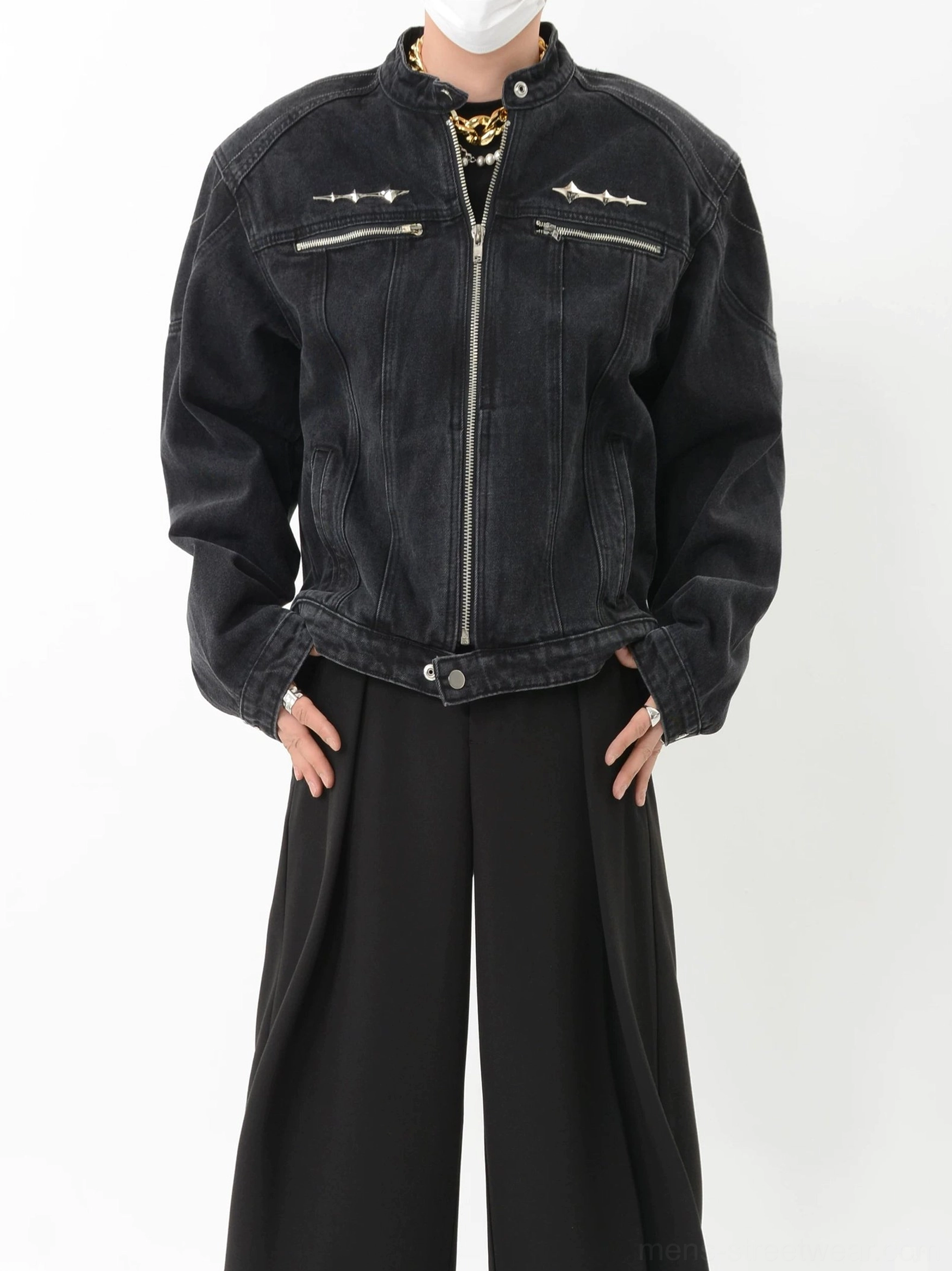 Washed black denim moto jacket front three quarter close up showing silver chest hardware zip closure and adjustable hem snaps