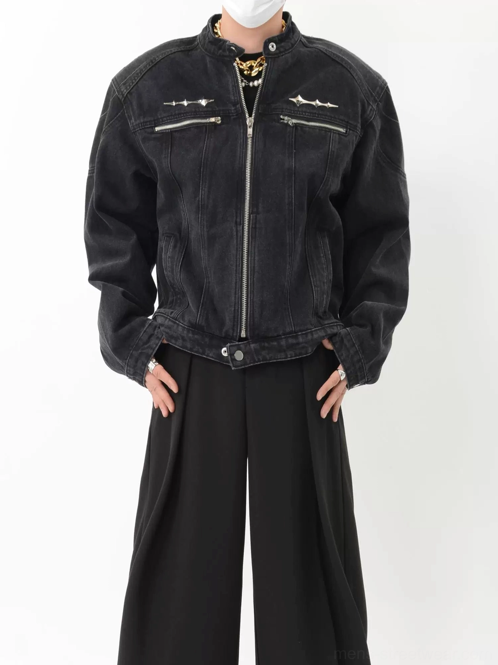 Front full body view of washed black denim moto jacket with silver zip pockets metal spike details and relaxed streetwear fit