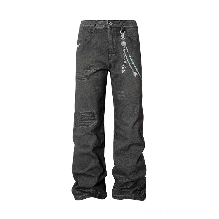 Washed black distressed chain-detail wide-leg jeans with oversized streetwear proportions and vintage punk denim character