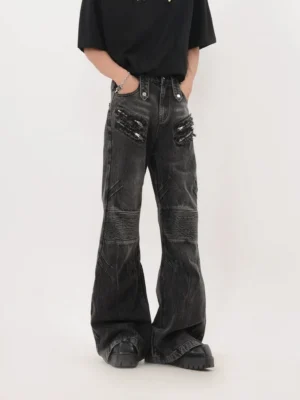 Washed black moto shred flared jeans front view with frayed studded pockets and ribbed biker knee panels