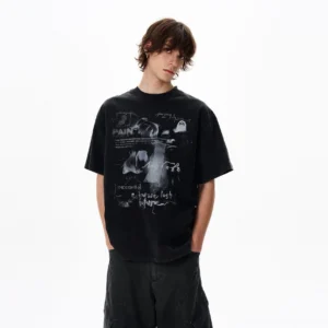 Washed black oversized grunge graphic T-shirt with PAIN lettering, abstract graffiti artwork, retro punk print, and relaxed drop shoulder streetwear fit