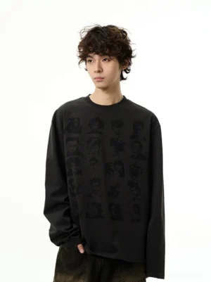 Washed black retro character portrait print long sleeve streetwear tee shown from the front with a relaxed drop shoulder fit and dark washed jeans