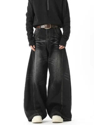 Washed black ripple wash ultra wide barrel jeans shown from the front with oversized Y2K streetwear silhouette and contrast stitching